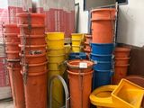 many buckets of different colors and sizes in a warehouse
