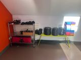 a room with a shelf and a rack of shoes