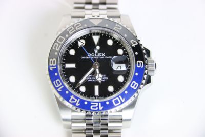 a rolex watch with a blue bezel on it