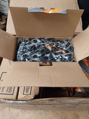 a cardboard box with a bunch of screws inside of it