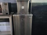 a silver refrigerator and a microwave in a room