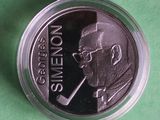 a close up of a coin with a picture of a man