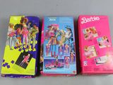 three barbie dolls are sitting next to each other on a table