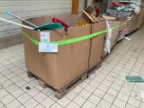 a cardboard box with scissors and other items in it on a pallet