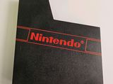 the nintendo logo is displayed on the back of a black box