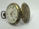 a close up of a pocket watch with roman numerals on it