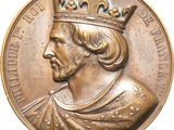 une image représentant une médaille de bronze sur laquelle figure un homme coiffé d'une couronne
