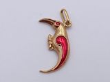 a picture of a red and gold charm with a bird