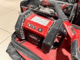 a red and black tool bag with tools inside of it