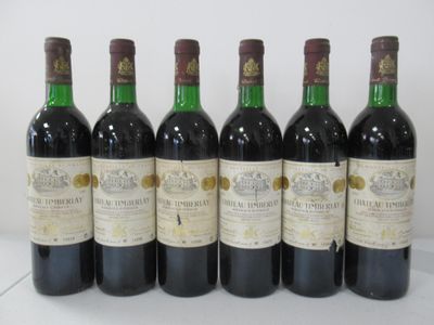 six bottles of wine are lined up in a row on a table