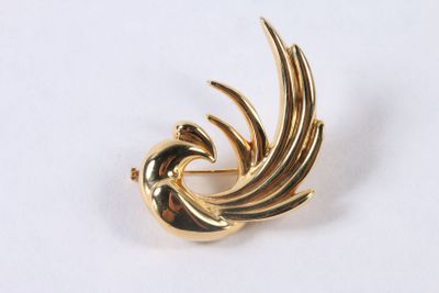 an image of a gold plated brooch with a bird on it