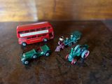 four toy vehicles that are sitting on a table