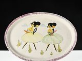 a white plate with a picture of two girls on it