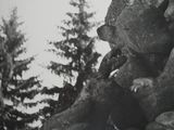 black and white photograph of a statue of a man holding a dog