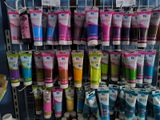 many tubes of toothpaste on display in a store