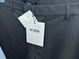 a close up of a pair of black pants with a tag on it