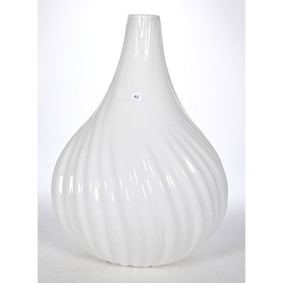 a white vase that is sitting on a table
