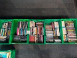 a lot of dvds in a green box on the floor
