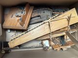 a cardboard box full of wood pieces and tools