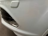 a close up of a car ' s front bumper with a hole in it