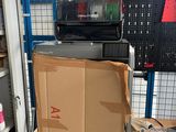 a box on a cart in a warehouse with other items