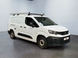 the white van is parked in a large room with a clock on the wall