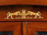 a wooden cabinet with a gold lion decoration on it