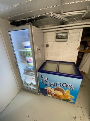 a refrigerator that has a box of ice cream inside of it