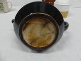 a black pot that has a brown substance in it