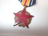 medal with a red star on it on a white surface