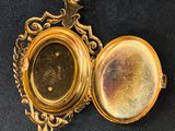 an image of a gold locke with a picture inside of it
