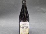 a close up of a bottle of wine on a table