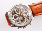 a close up of a watch on a white surface