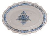 a blue and white plate with a flower design on it