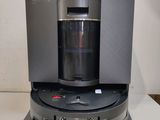 the coffee maker is sitting on top of the table