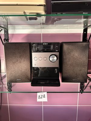 two speakers that are on a glass shelf in a bathroom