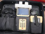 a case with a cell phone and other items in it