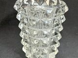 an image of a clear glass vase on a black surface