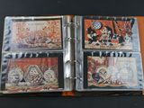 four cd ' s in a binder on a table
