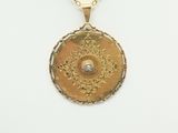 an image of a gold necklace with a medallion on it