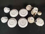 a group of cups and saucers sitting on a table