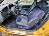 a yellow car with blue seats in the back of it