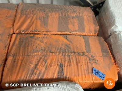 a bed that has a lot of pillows on top of it