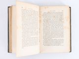 an open book on a white surface with a white background