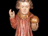 a statue of a man holding a skull in his hand