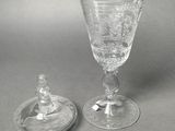 pair of cut glass goblets and a lid