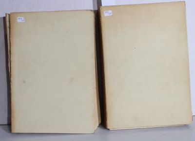 two old books sitting on top of a table next to each other
