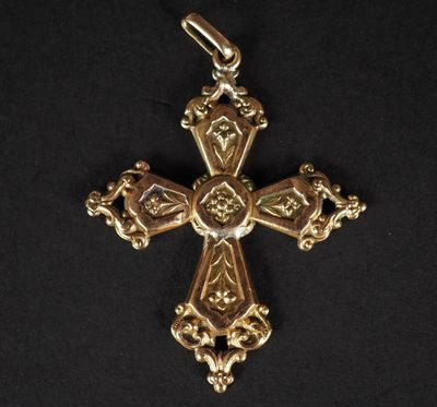 une croix dorée ornée d'un cœur, sur fond noir