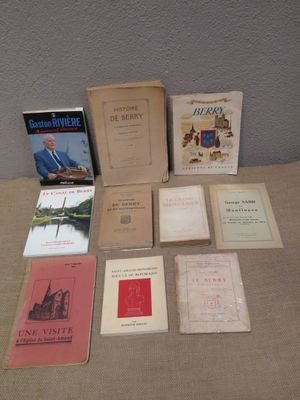 several books are sitting on a table in front of a wall