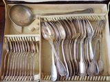 de nombreuses cuillères et cuillères-cuillères dans une boîte contenant une cuillère et un repose-cuillère